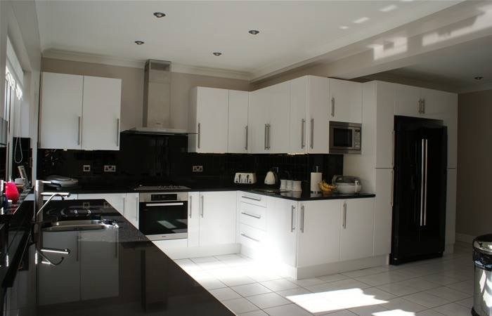 Gloss kitchen with black worktops