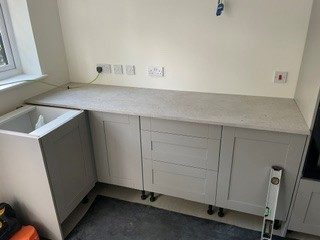 Worktops on: Worktops cut, joined and fitted tight to the wall.