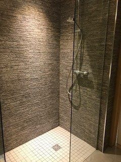 Wet room shower with stone-effect tiles